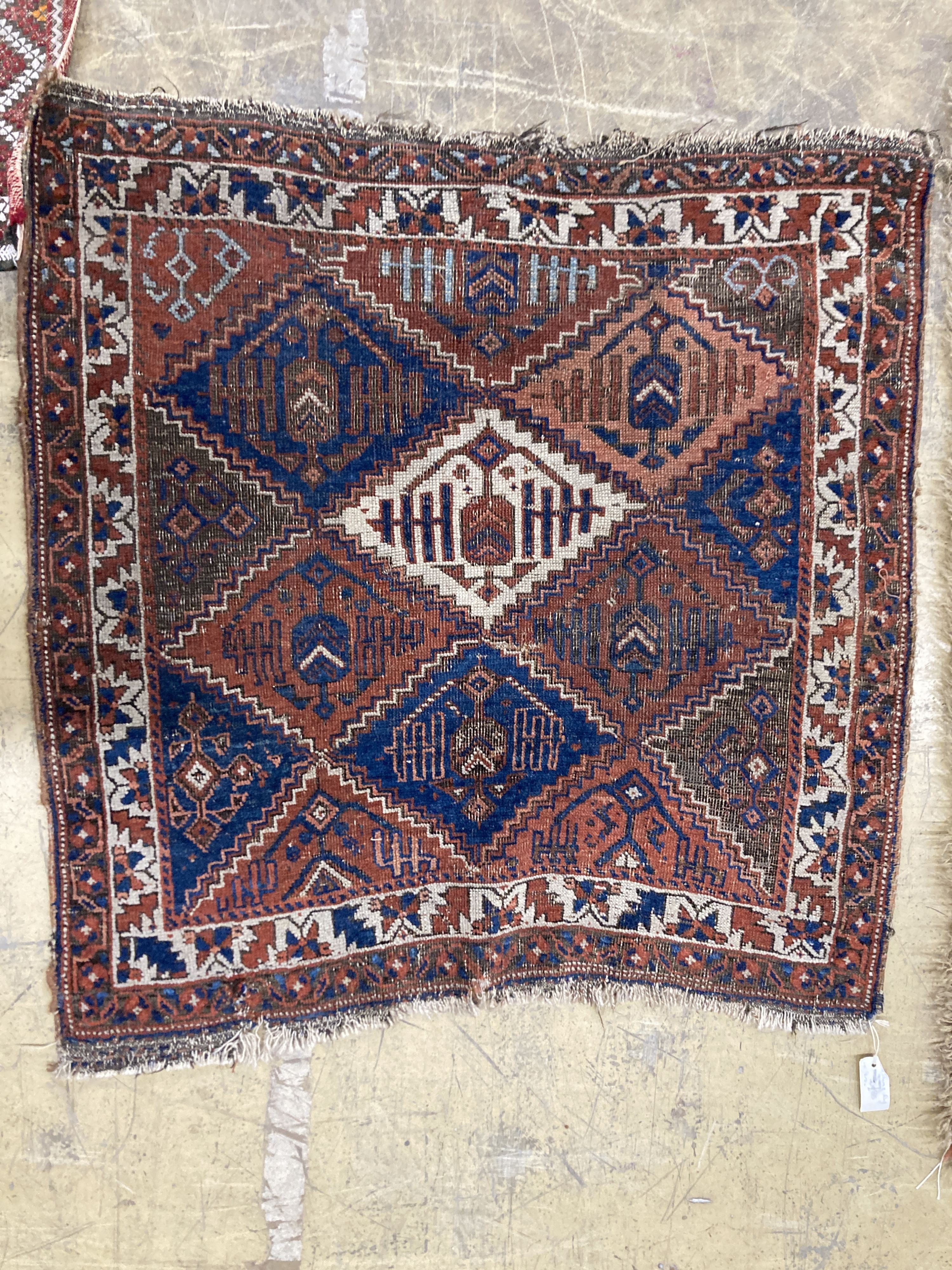 An antique Caucasian red ground rug, 250 x 125 cm and a smaller Shiraz rug.